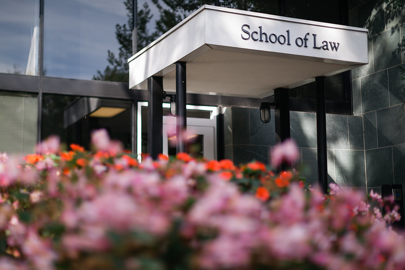 Image of outside of School of Law building with flowers around