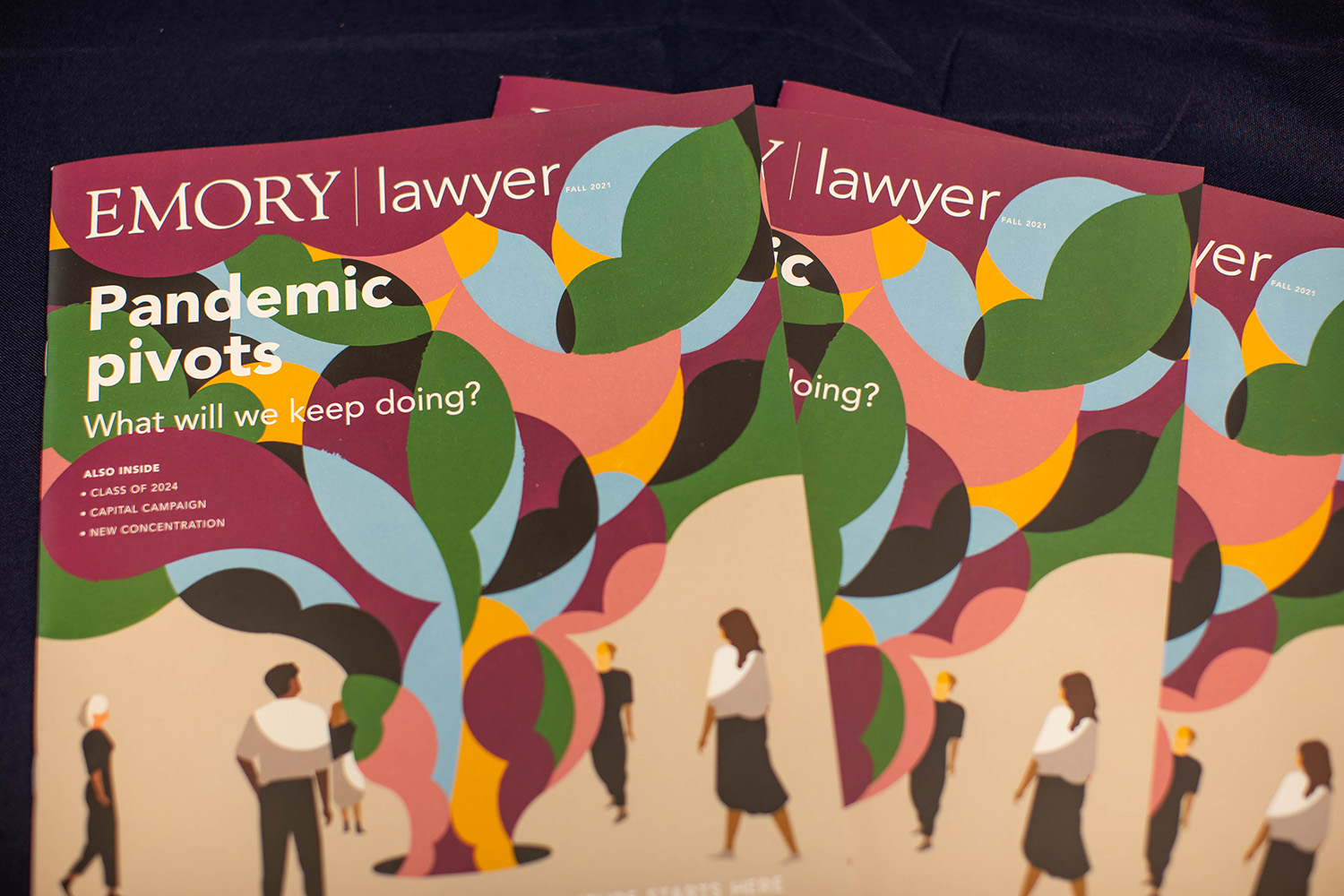 Several copies of LAWYER magazine laid out on dark background