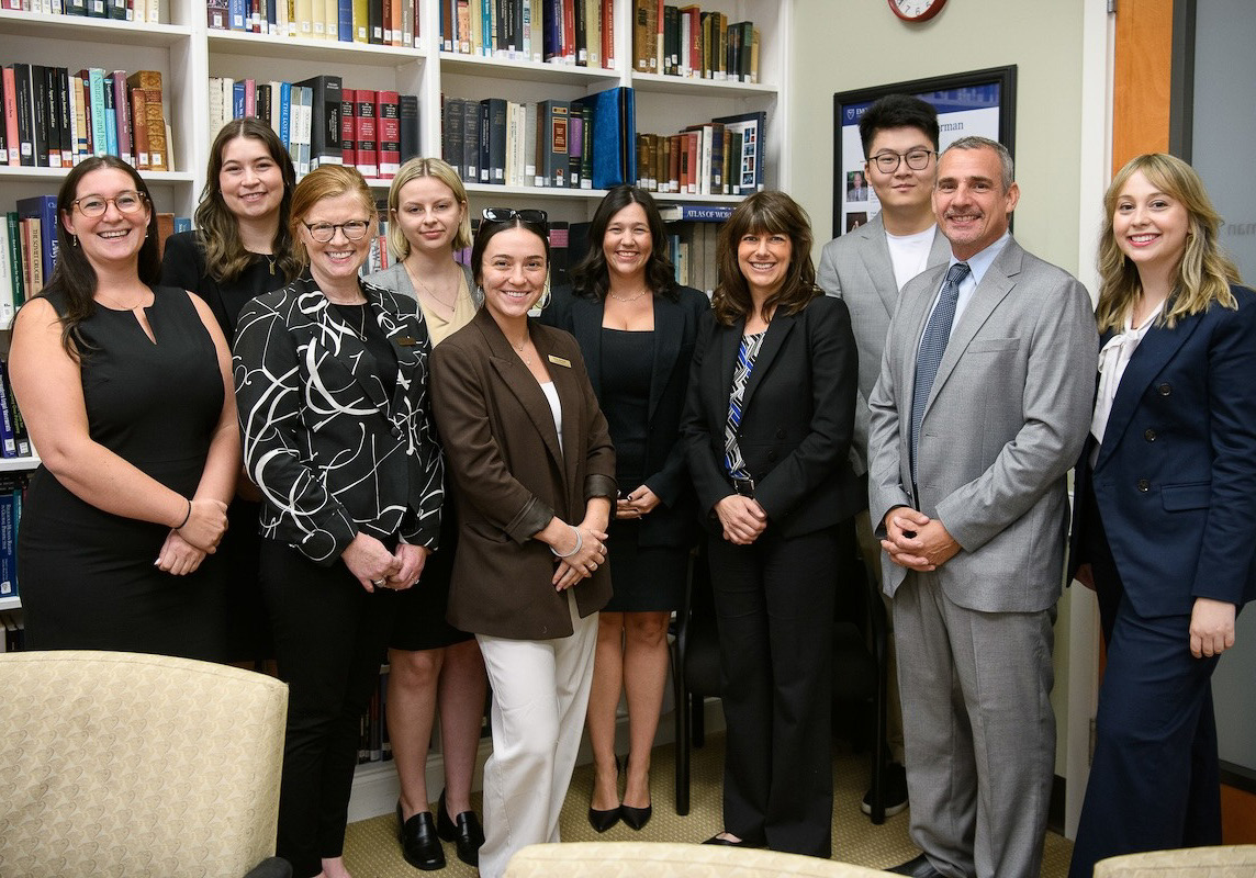 Prelogar poses for a picture with Emory students